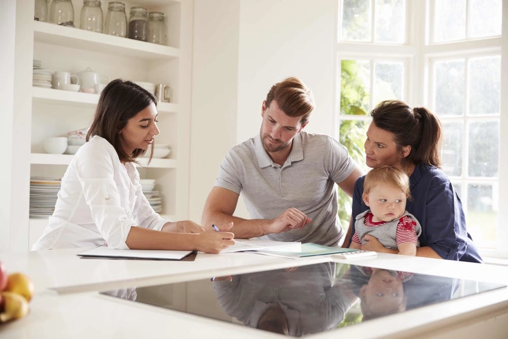 financial advisor helping young couple with baby create a plan