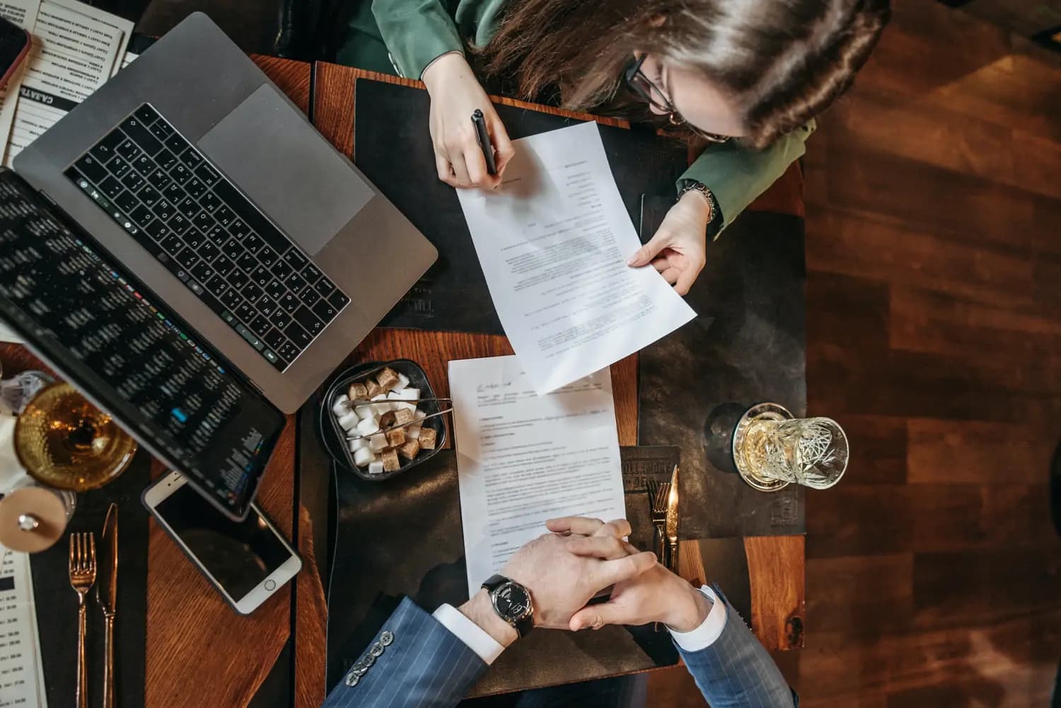 a couple signing a document with a legal advisor